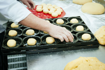 Close-up of chef holding dough in commercial kitchen