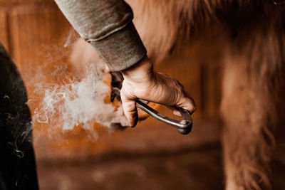 Cropped image of man holding metal
