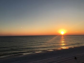 Scenic view of sea against clear sky during sunset