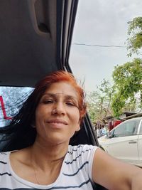 Portrait of smiling woman in car