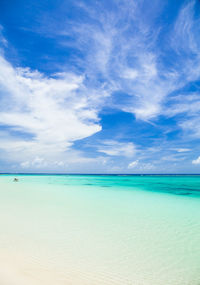 Scenic view of beach against blue sky