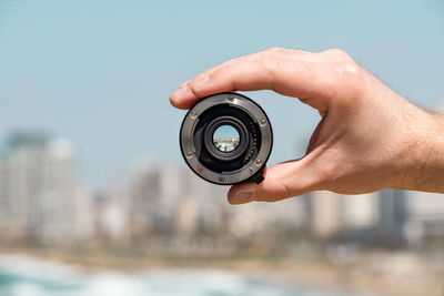 Midsection of person holding camera
