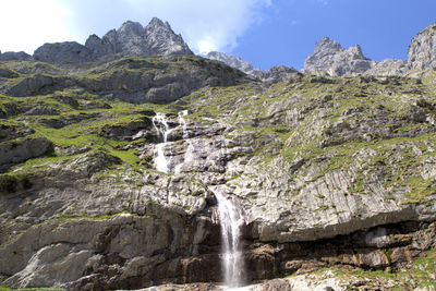 Scenic view of waterfall against sky