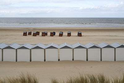 Lifeguard hut on beach against sky