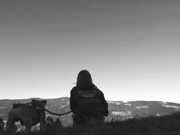 Man with dog against sky