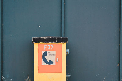 Close-up of military emergency telephone box against wall