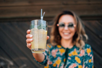 Portrait of a smiling young man drinking glass