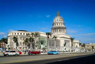 View of city street against blue sky