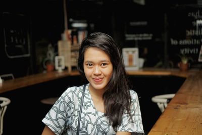 Portrait of young woman sitting outdoors