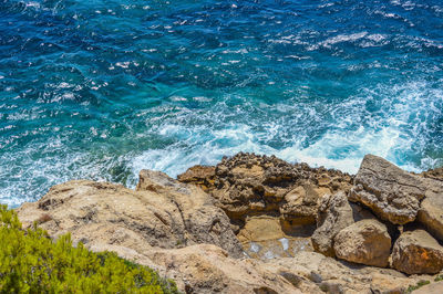 Scenic view of sea against rocks