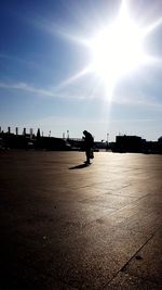 Silhouette man on runway against sky
