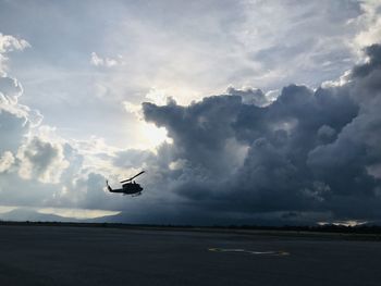 Low angle view of airplane flying against sky