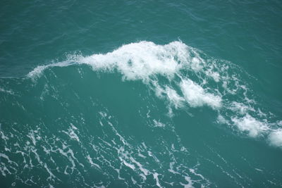 High angle view of waves splashing in sea