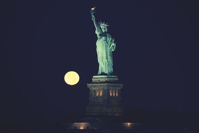 Low angle view of statue at night