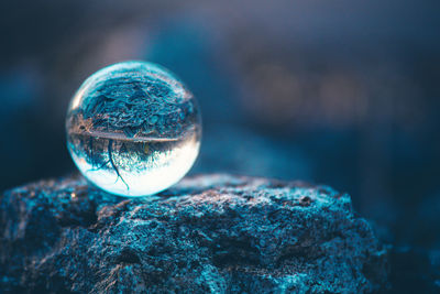 Close-up of crystal ball on rock