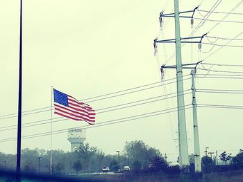 Low angle view of flags against clear sky