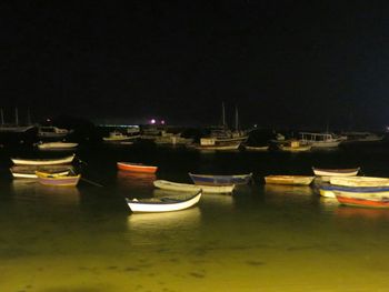 Boats in harbor at night