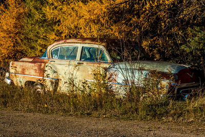 Abandoned car on field