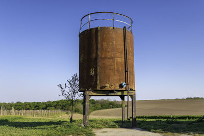 Lifeguard hut on field against clear sky