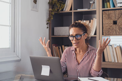 Woman using laptop while sitting at home