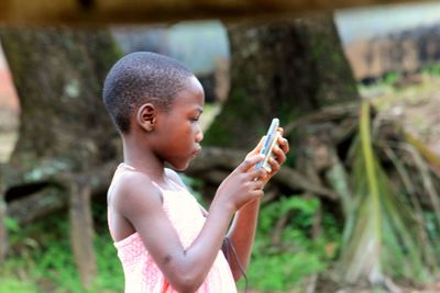 Side view of boy looking at camera