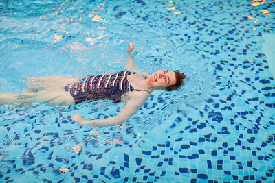 High angle view of boy swimming in pool