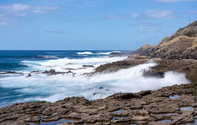 Large waves crash on the shoreline of ka'ena point on the extreme west coast of oahu in hawaii