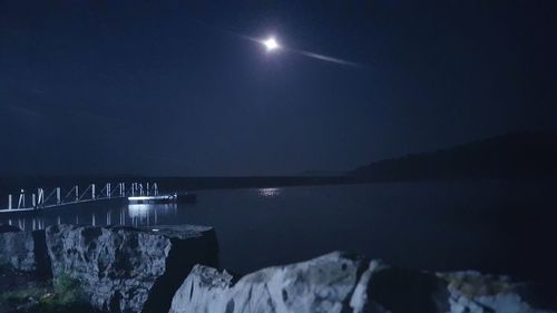 Scenic view of sea against clear sky at night