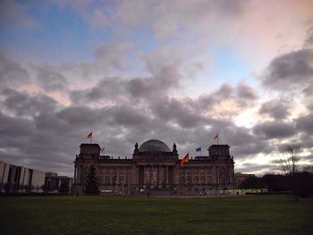 Buildings against cloudy sky