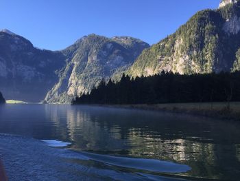 Scenic view of lake and mountains against clear sky