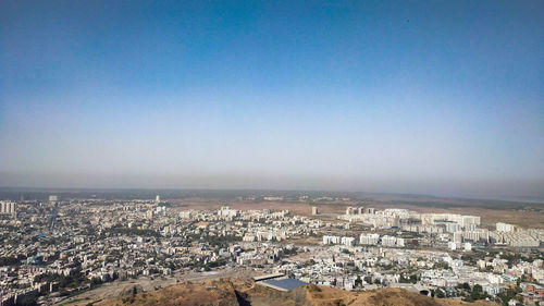 High angle view of townscape against blue sky