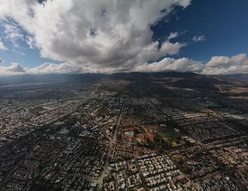 High angle view of city against cloudy sky