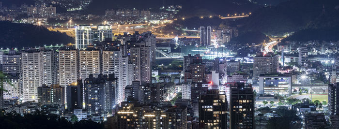 Aerial view of illuminated buildings in city at night