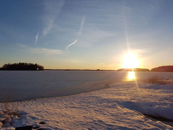 Scenic view of frozen sea against sky during sunset