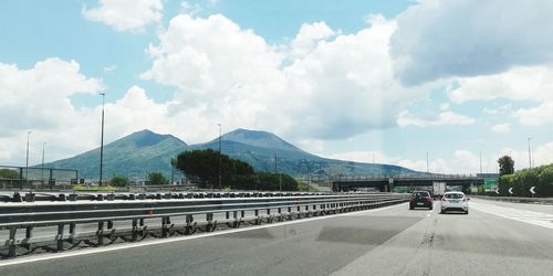 Cars on road against sky