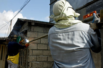 Close-up of woman standing against wall