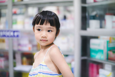 Portrait of cute girl standing in store