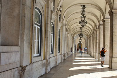 Rear view of man walking in historic building