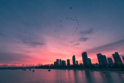 Scenic view of buildings against sky during sunset