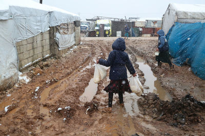 A refugee child during a snowfall on a syrian refugee camp near the turkish border.