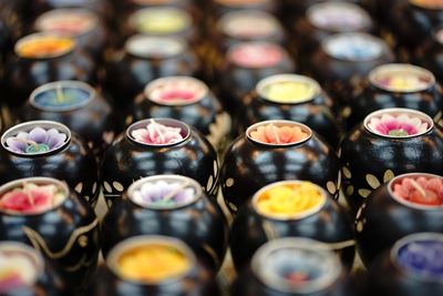 Full frame shot of colorful candles arranged on table