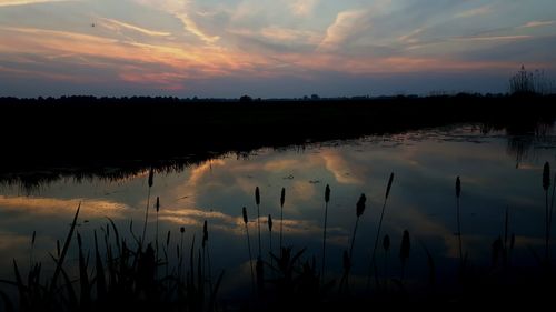 Scenic view of lake against sky during sunset