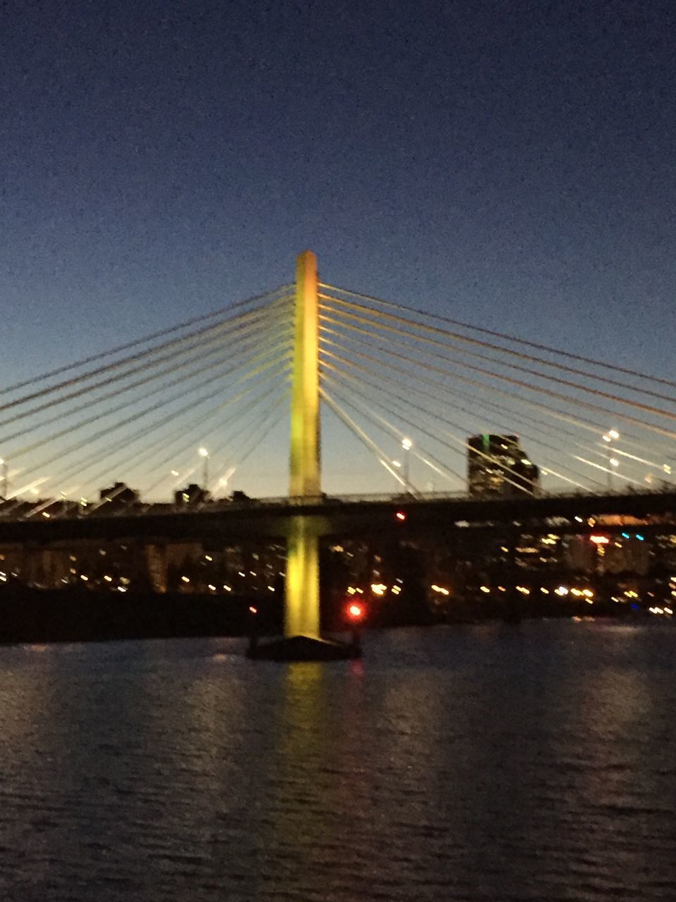 BRIDGE OVER RIVER AGAINST SKY AT NIGHT