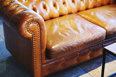 High angle view of orange on  vintage leather sofa