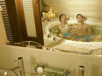 Couple relaxing in bathtub