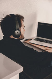 Young woman using laptop at home