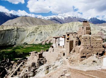 Panoramic view of snowcapped mountains against cloudy sky