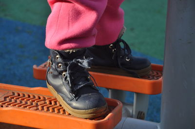 Low section of man wearing shoes