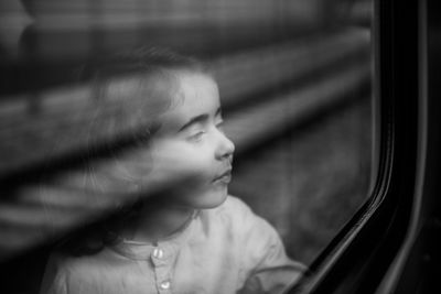 Cute girl looking through car window