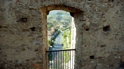 View of old wall through window